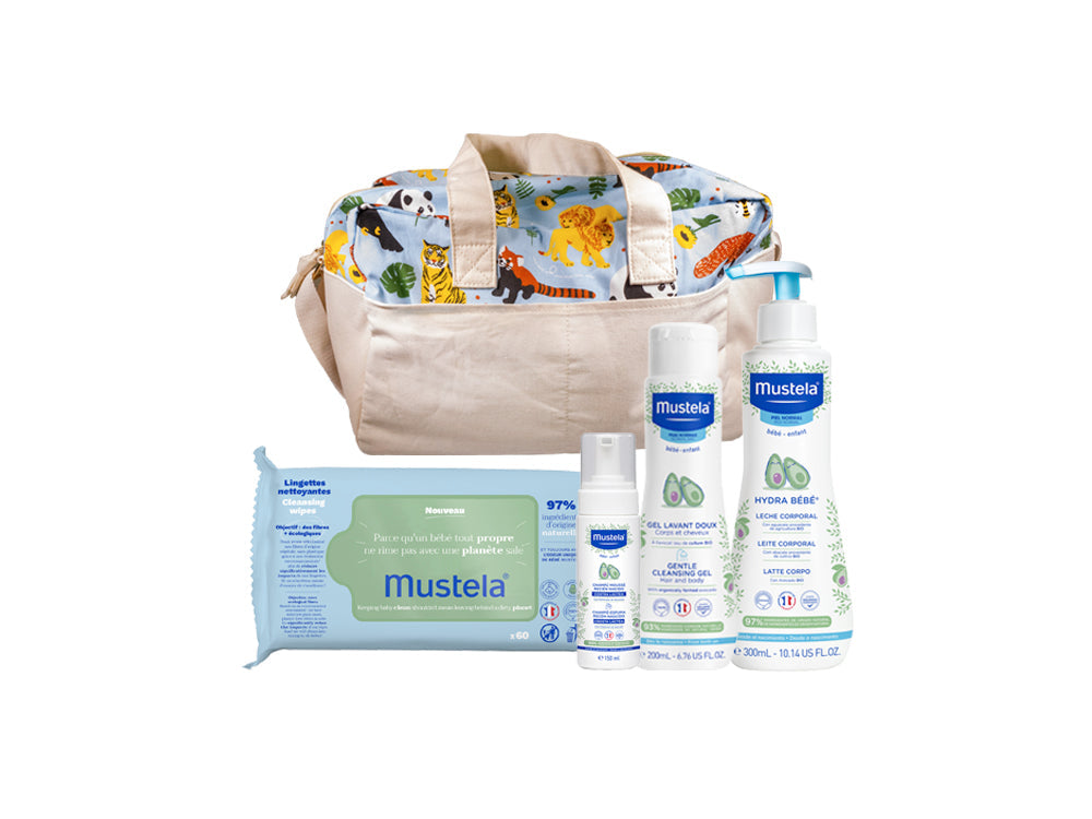 Canastilla de bebé color gris, con productos de cuidado e higiene básicos de Mustela, ideal para regalar a recién nacidos.
