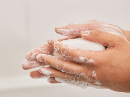 Una madre limpia con el jabón hidratante para manos, cara y cuerpo la piel seca de su bebé. - Mustela España - 3